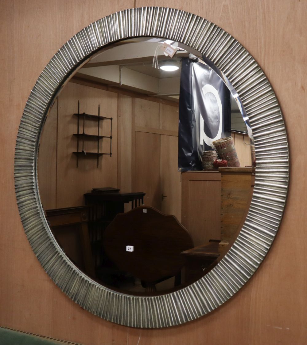 A large modern circular silvered metal wall mirror, Diameter 136cm